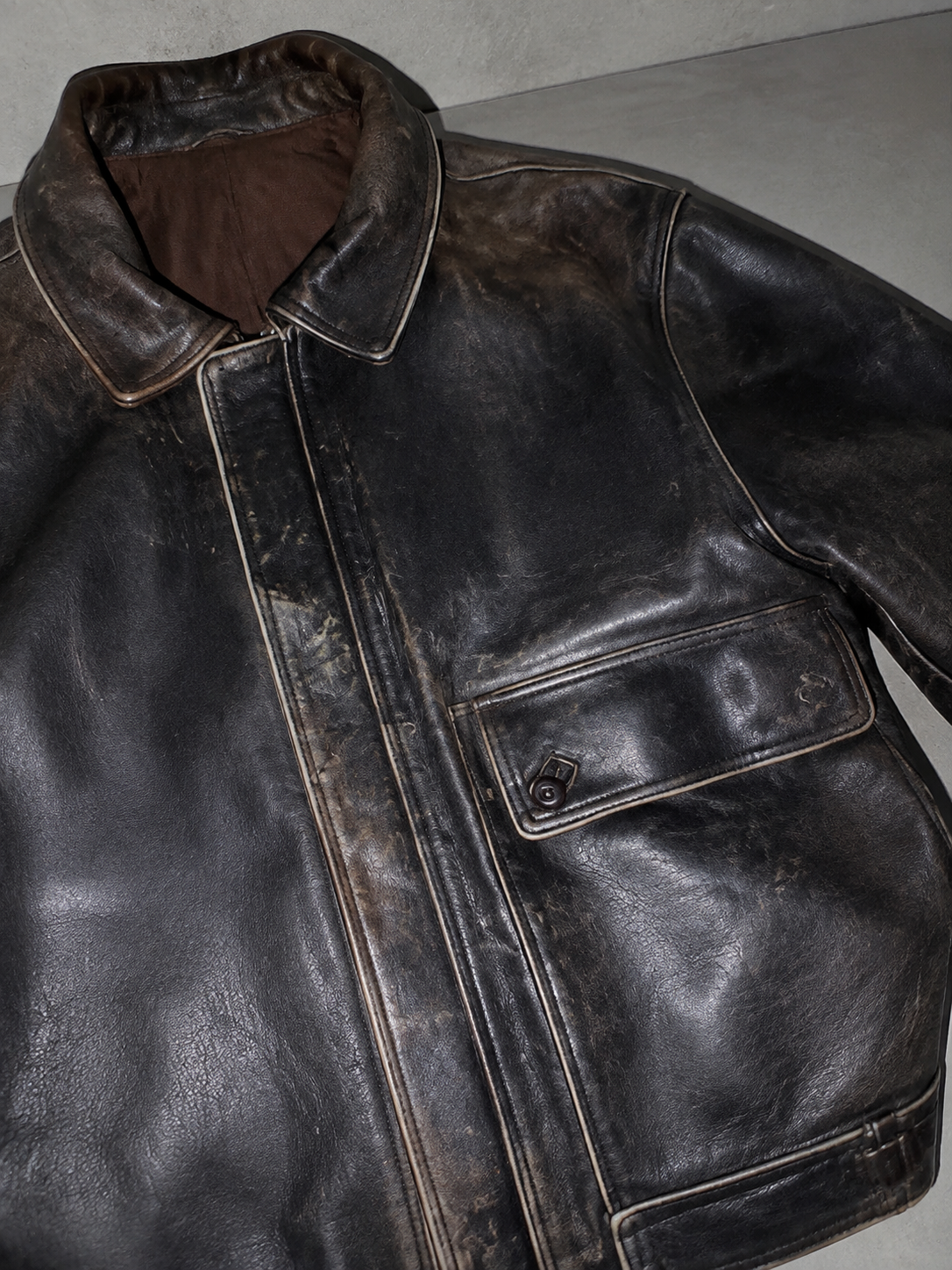 Women's Oversized Distressed Dark Brown Leather Jacket — Macro Fabric Texture Detail