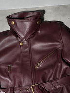 Women's Burgundy Faux Leather Belted Moto Jacket with High Funnel Neck — Macro Fabric Texture Detail